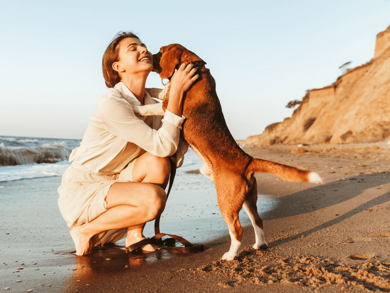 a women hugging a pet dog
